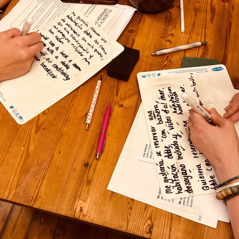 Students working to translate and mark work on whiteboards